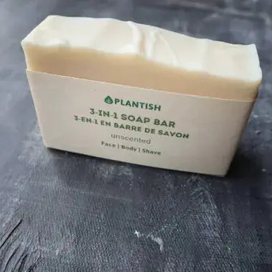 Bar of soap with text on its wrapper against a gray background
