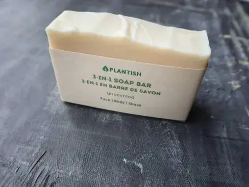 Bar of soap with text on its wrapper against a gray background