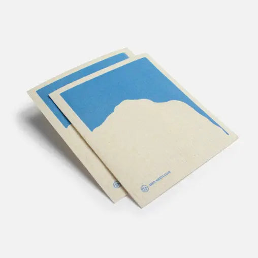 A Swedish sponge cloth with blue mountain design on a white background