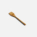 A wooden spatula resting on a clean white surface, showcasing its natural texture and design for cooking purposes.