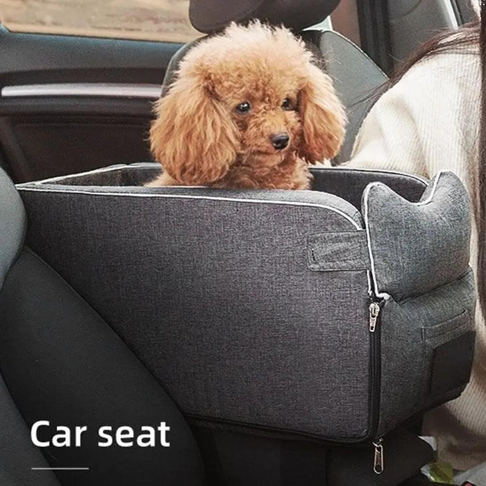 Dog sitting in a gray pet car seat inside a vehicle
