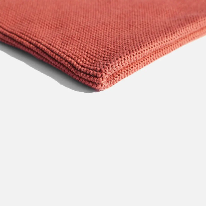 Folded red fabric on a white background