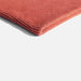 Folded red fabric on a white background