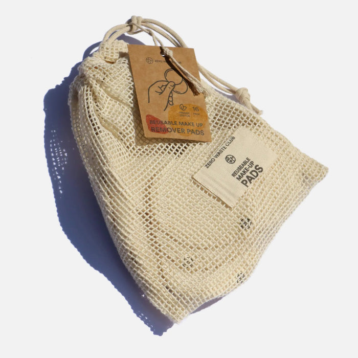 Beige mesh bag with a drawstring and a brown tag on a white background