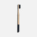 Bamboo toothbrush with black bristles on a white background